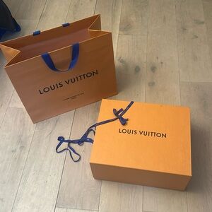 Large Louis Vuitton packaging items: bag, box, and ribbon